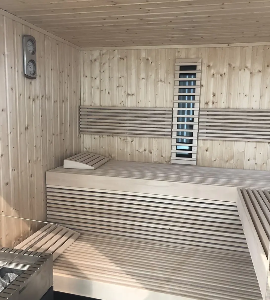 Sauna with slatted timber benches and infrared panels